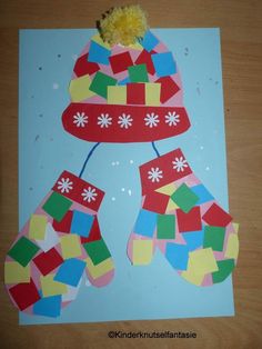 a paper cut out of christmas stockings and mittens with pom - poms