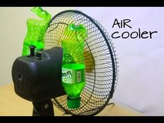 an air cooler sitting on top of a table next to a fan with bottles in it