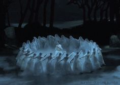 a group of people standing on top of ice in the water at night with trees behind them