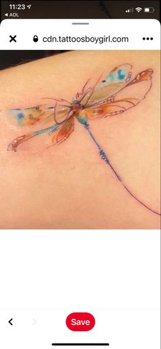 an image of a tattoo on the back of a woman's shoulder with a dragonfly