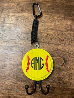 a key chain with a baseball on it and an amg hook attached to it