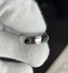 a close up view of a wedding ring on top of a white towel in front of a window