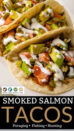 two tacos on a white plate with the title smoked salmon tacos