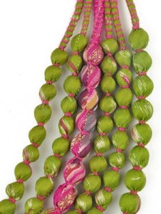 three strands of green and pink beads