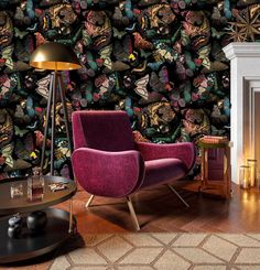 a living room filled with furniture and a wallpaper covered in lots of colorful butterflies