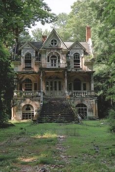 an old abandoned house in the woods with stairs leading up to it's second story