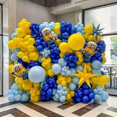 a bunch of balloons that are in the shape of minionsettes and starfish