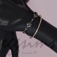 a black mannequin with a gold bracelet on it's arm and an arrow charm