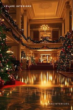 An opulent hotel lobby decorated for Christmas with multiple large Christmas trees illuminated with lights and ornaments, placed along a polished corridor. Garlands with lights drape along the balcony railings, with high ceilings, classic columns, and chandeliers enhancing the luxurious setting. Balcony Railings, Classic Column, Lobby Decor, Large Christmas Tree, Balcony Railing, Light Garland, High Ceilings, The Balcony, Winter Home Decor