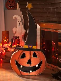 a pumpkin with a witch hat on it sitting in front of a fireplace decorated for halloween