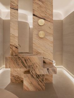 an artistic bathroom with marble walls and flooring