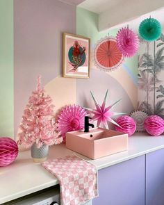 pink and green decorations are on the wall in this room, along with other items