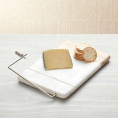 a cheese grater and some crackers on a white plate