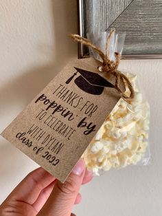 a hand holding a tag that says thanks for popcorn