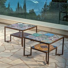 two tables sitting on top of a stone floor