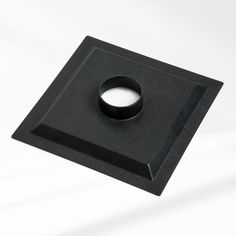 a black square object with a hole in the middle