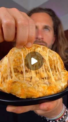 a man holding a plate with some food on it