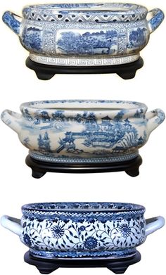 three blue and white dishes with handles on each side, one is holding an oval platter