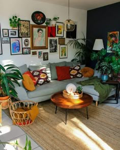 a living room filled with furniture and lots of pictures on the wall above it's coffee table