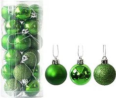 green christmas ornaments are in a clear package