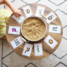 a child's hand is on the top of a coffee table with matching cards