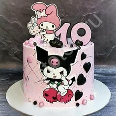 a pink cake decorated with cartoon characters and hearts