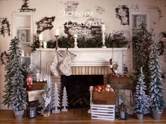 a fireplace decorated with christmas trees and stockings