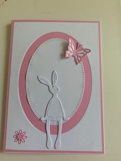 a pink and white card with a rabbit on it