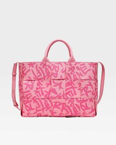 Make a bold statement with the Pink Graffiti Tote Bag, a playful and eye-catching accessory that's perfect for adding a pop of color to any outfit. This stylish tote features a vibrant pink color and a striking graffiti print, adding a touch of urban edge to any ensemble. The woven construction and double handles provide both style and functionality, while the spacious interior offers plenty of room for your essentials. Cheap Pink Bags With Letter Print, Luxury Pink Canvas Shoulder Bag, Luxury Pink Tote Baguette Bag, Luxury Pink Bucket Tote Bag, Luxury Pink Tote Flap Bag, Hot Pink Shopping Bags, Luxury Pink Tote Box Bag, Pink Wallpaper Shopping Bag, Pink Square Tote Bag