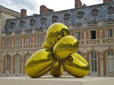 a sculpture in front of a large building