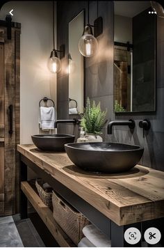 a bathroom with two sinks and mirrors in it's dark wood cabinetry, along with hanging lights