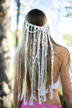 the back of a woman's head with white crochet