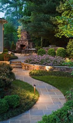 an outdoor patio with stone steps and landscaping