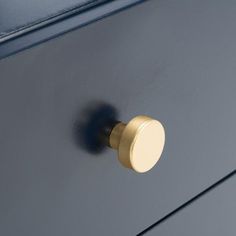 a close up of a metal cabinet with a knob on it's front door