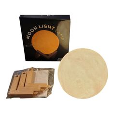 the moon light lamp is in its box and next to it's package contents