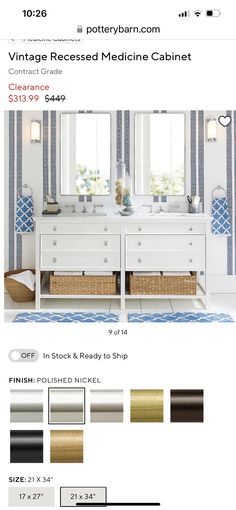 a white bathroom with blue and gold stripes on the walls, two sinks and mirrors