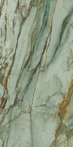 the marble is green and brown with gold streaks on it's edges, as well as some other colors