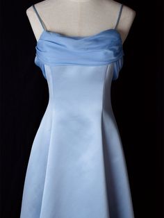 Step into timeless elegance with this Vintage Blue Satin Gown. Crafted from luxurious satin, this dress features delicate spaghetti straps that provide a graceful and feminine silhouette. The highlight of this gown is its unique winged back design, adding a touch of whimsy and sophistication. Perfect for formal occasions, evening events, or any special celebration, this elegant dress ensures you'll make a stunning entrance. The vintage blue hue adds a classic touch, making it a versatile additio