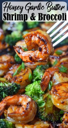 shrimp and broccoli being cooked in a skillet with a fork stuck into it