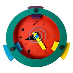 a colorful clock with different shapes and colors on it's face is shown from above