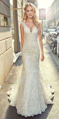 a woman in a wedding dress is walking down the street with her hand on her hip