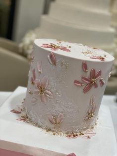 a white cake with pink flowers on it