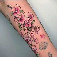 a woman's arm with pink flowers on it