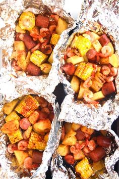 four foil packets filled with different types of food