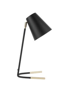 a black and gold lamp on a white background with two sticks sticking out of it