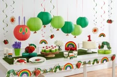 the very hungry caterpillar birthday party is set up with cake and cupcakes