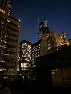 some very tall buildings at night time