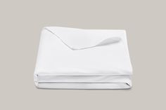 the white sheets are folded and ready to be used as a bedding set or pillowcase