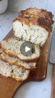 a loaf of bread sitting on top of a wooden cutting board