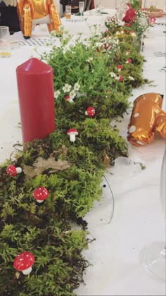 the table is covered with moss and candles